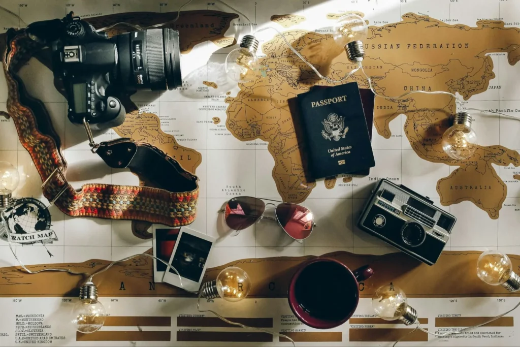 Passport, camera and world map laid out while planning a Europe trip